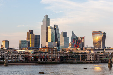 Modern skyscrapers and iconic buildings along the River Thames in London, UK.