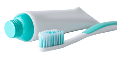 Toothbrush and toothpaste tube close up.