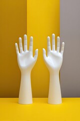 Two white mannequin hands reach upwards, against yellow and gray background