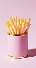 Fries in a pink container with gold trim against a pale pink backdrop