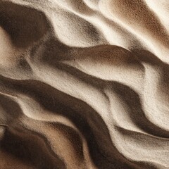 Wavy patterns in sand, alternating light & dark creating textured ripples