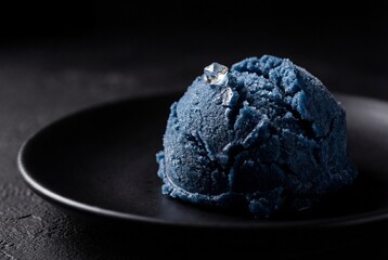 Macro View of Frozen Blue Spirulina Dessert Scoop on Black Plate