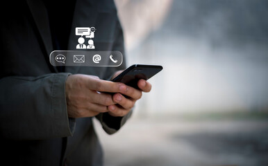 Businessman using Smart Phone with the email, call phone, address, Chat message icons.Customer support hotline Contact us people connection.