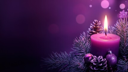Lit pink candle surrounded by christmas decorations and evergreen branches
