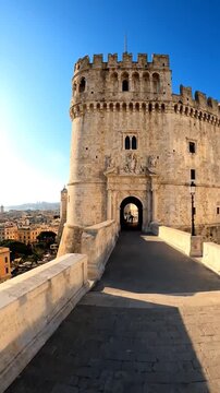 Majestic stone fortress with crenellations and arched entrance under a clear blue sky