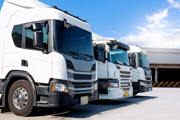 Semi Trucks on The Parking Lot at Warehouse. Tractor Truck. Shipping Cargo Container. Trucks Loading Goods at Dock Warehouse. Distribution Warehouse. Big rig. Freight Logistics Truck Transport.	
