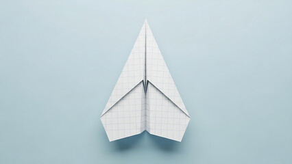 A white paper airplane on blue