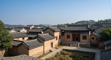 Panoramic view of traditional Asian village. Rows of terracotta-colored buildings with dark gray tile roofs cluster around a central courtyard