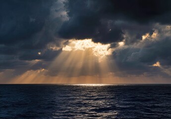Sunbeams pierce dark clouds over a serene ocean horizon at sunset