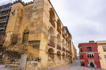 A scenic view of the historic Mosque Cathedral exterior and traditional colorful buildings in the old town of Cordoba, Andalusia, Spain.