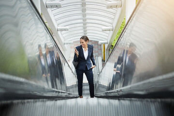 Business, smile or woman on escalator with phone, schedule change or online networking in morning....
