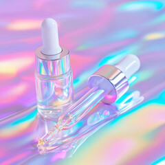 Clear dropper bottle and applicator on a shimmering, iridescent background with vibrant pink, blue, and yellow reflections