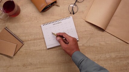 Writing notes on a calendar in December