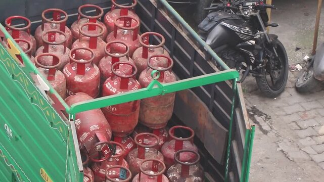 Dedicated laborers upload LPG cylinders to a truck  for efficient doorstep delivery, ensuring energy access in urban areas.