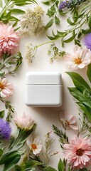 White jar surrounded by colorful blooms & green leaves