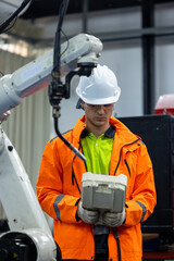 Engineer operating robot arm in electrical industry, Engineer working with robotic equipment...