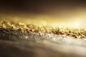 Gold scratch off card surface with sparkling texture and shimmering light, creating luxurious and elegant abstract background for creative design or promotional use