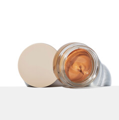 Foundation makeup in glass jar with lid off