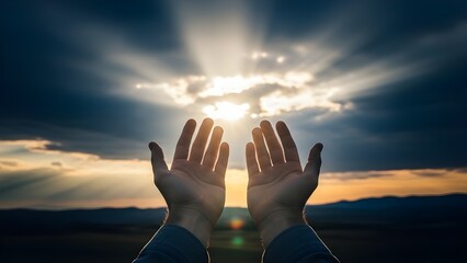 Hands reaching up to the sky with sunrays breaking through dramatic clouds