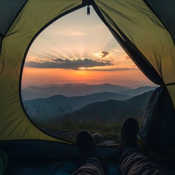 Serene mountain sunset viewed from a cozy tent