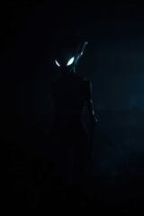 Silhouette figure with glowing eyes in the darkness
