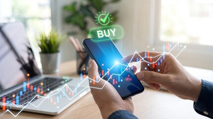 Person using a smartphone to trade stocks or cryptocurrency with a laptop and financial charts