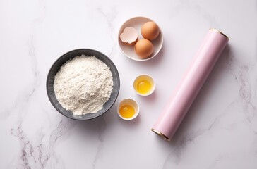 Fresh baking ingredients with eggs flour and rolling pin on marble surface