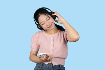 young teen girl happy smile enjoy music from phone, listening music by headphone studio isolated