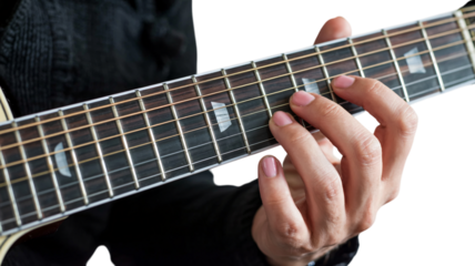 Closeup of fingers playing guitar chords on fretboard