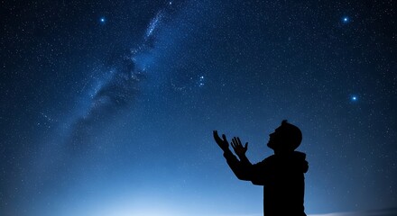 Silhouette of man looking at stars.
