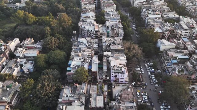 An expansive drone footage of Delhi Karol Bagh showcasing tightly packed housing, emerging modern developments, and natural green belts blending into the rapidly evolving urban environment.