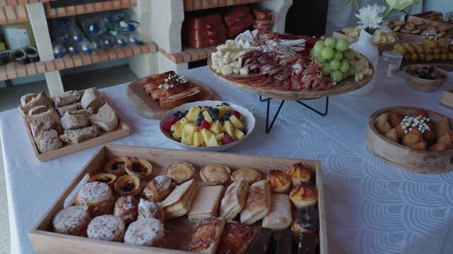 Assorted pastries bread fruit and meats arranged on a buffet table