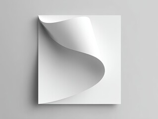 White sheet with curled corner casts soft shadow on gray surface