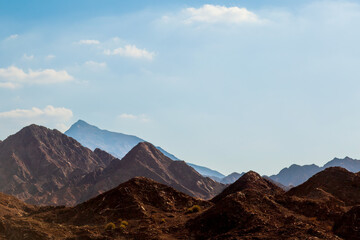 Desert Mountain Landscape With Rugged Rocky Hills Under A Bright Blue Sky