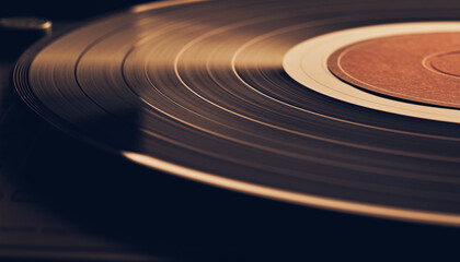 Close-up of a vinyl record spinning on a turntable with a brown label.