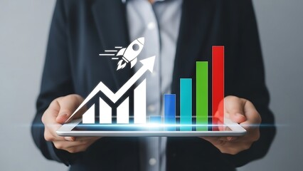 Businessman analyzing rising chart and graph on tablet in office