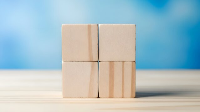Four beige rectangular blocks stacked on a table