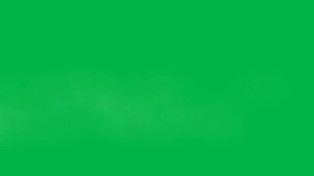 White misty fog rolling across the bottom on green screen chromakey background. Ideal for 2d animated cartoon animation creating eerie atmospheres in horror or haunted scenes.