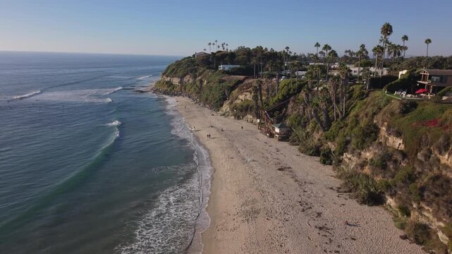 Swamis Beach in Encinitas, California. Drone 4k video of cliffs, sand, and ocean.