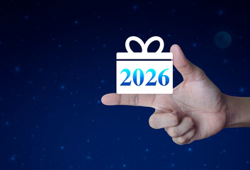 Gift box happy new year 2026 flat icon on finger over fantasy night sky and moon, Business 2026 shopping online concept