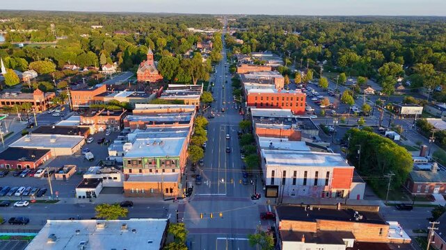 Drone view above Grand River Ave in Howell, Michigan, USA with Livingston County Courthouse at sunset, aerial view