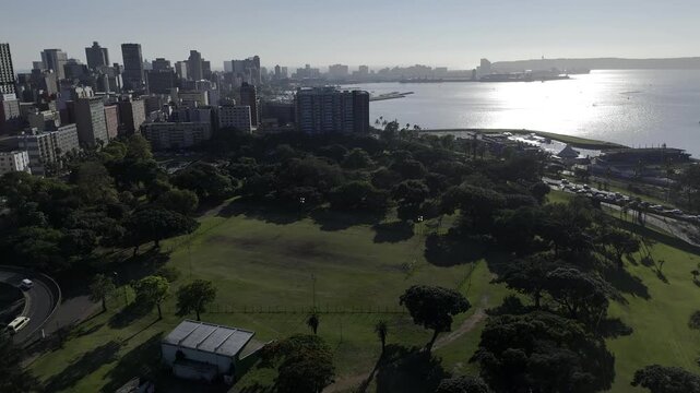Drone flies east over Albert Park in the early morning on the southeast side of downtown Durban, South Africa