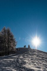 Silhouette of a man walking on the snow, Alps mountains