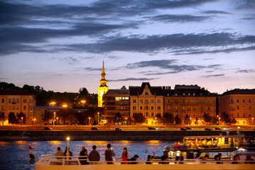 Old city at night, defocused sightseeing boat with people