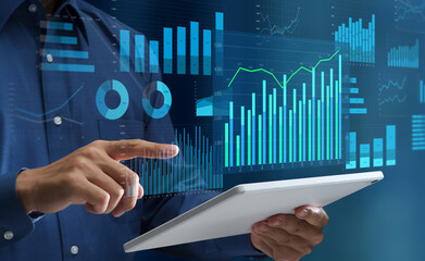 Data analysis and business intelligence. Visualization of KPIs. Graphs and statistical reports. Businessperson using tablet computer to look at analytics dashboard.