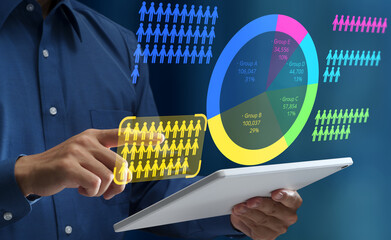Customer segmentation analysis and pie chart. Target market analysis. Businessman using tablet computer to analyze statistical audience data.