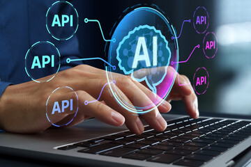 API and AI technologies. Business workflow automation. Platform for AI integration and data communication. Businessperson using laptop computer.