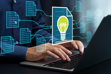 Knowledge management and semantic search of documents. Automated text summarization. Automated suggestion of document templates. Businessman using laptop computer.