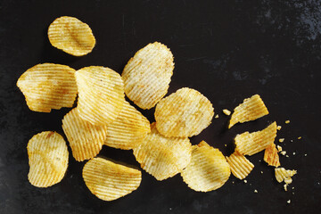 Potato chips on black