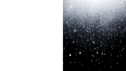 Sparkling white particles falling against dark background with bright light